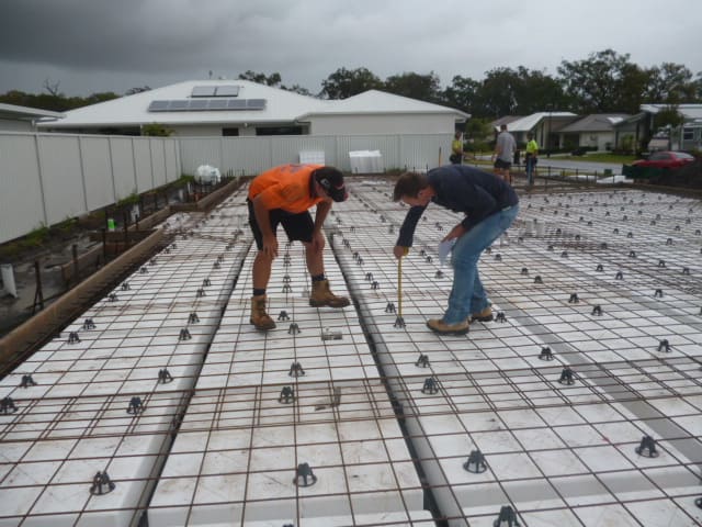 Engineers inspecting house slab preparations